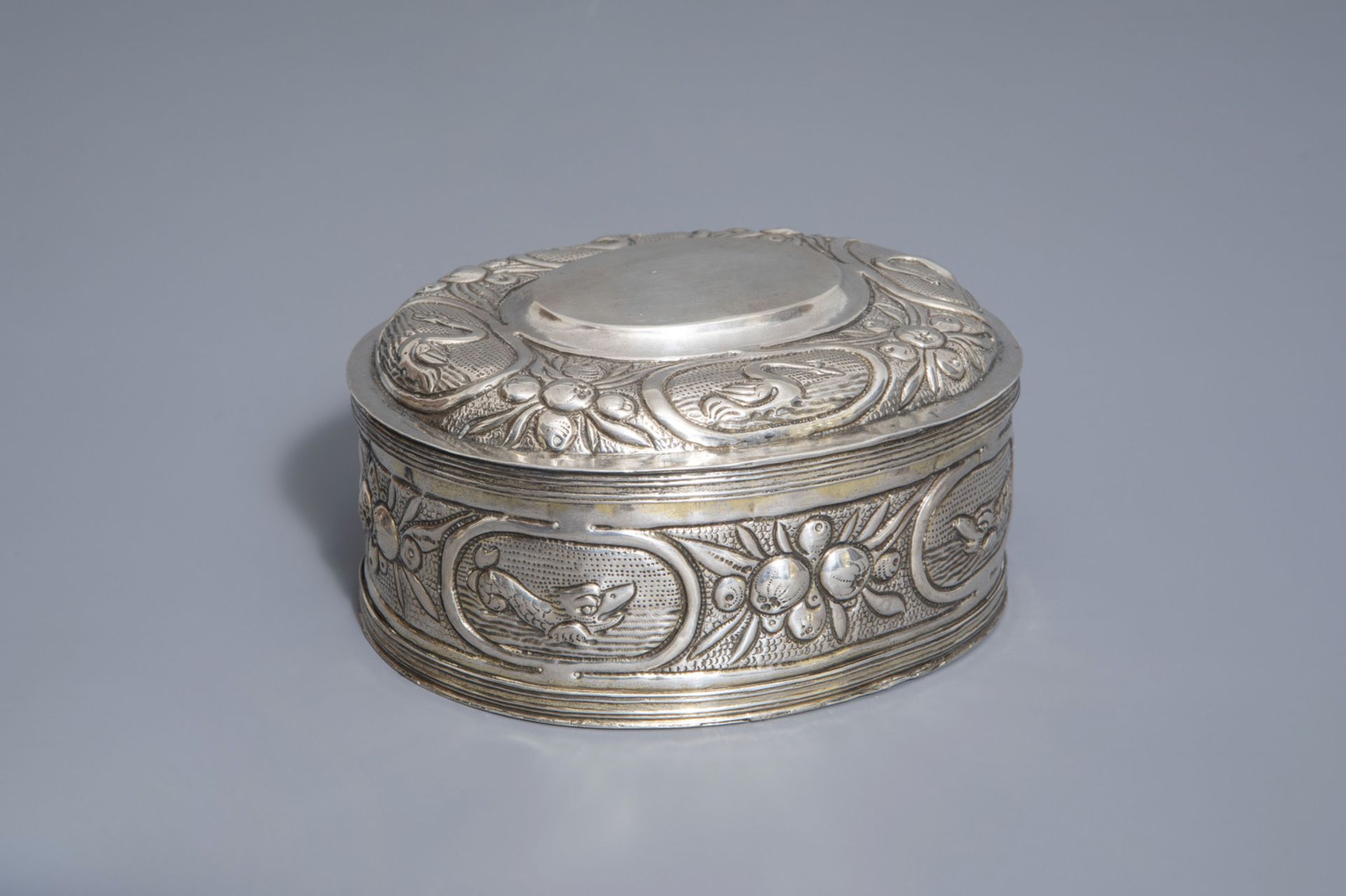 An oval shaped silver plated relief decorated tobacco box, various marks, 18th/19th C.