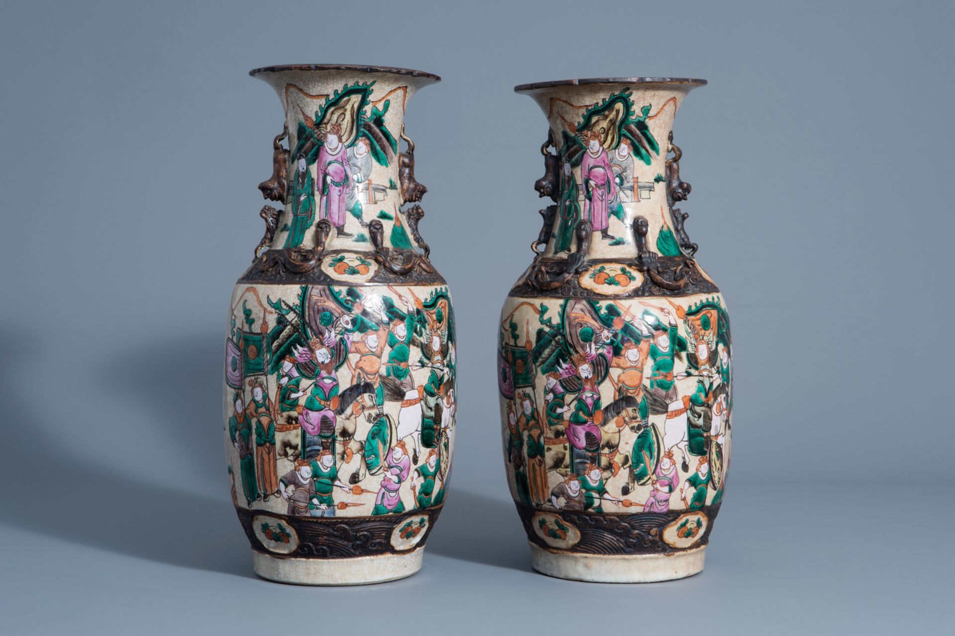 A pair of Chinese Nanking crackle glazed famille rose vases with warrior scenes, 19th C.