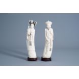A pair of Chinese carved figures of the emperor couple on wooden stands, about 1920