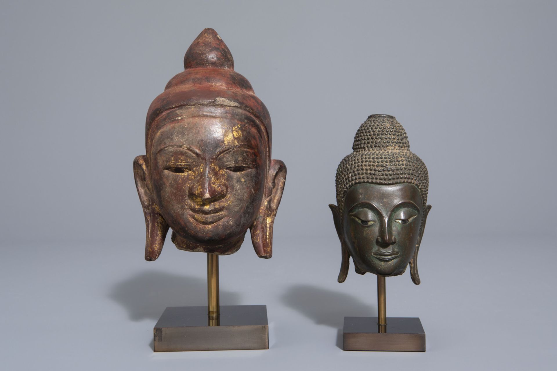 Two patinated bronze and gilt and polychrome painted stone Buddha heads, Burma/Thailand, 19th/20th C - Image 2 of 7