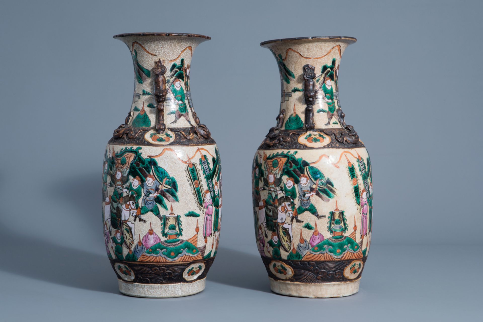 A pair of Chinese Nanking crackle glazed famille rose vases with warrior scenes, 19th C. - Image 4 of 6