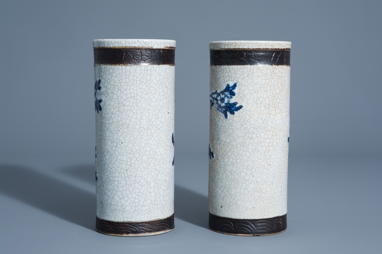 A pair of Chinese blue and white Nanking crackle glazed hat stands with floral design, 19th C. - Image 3 of 6