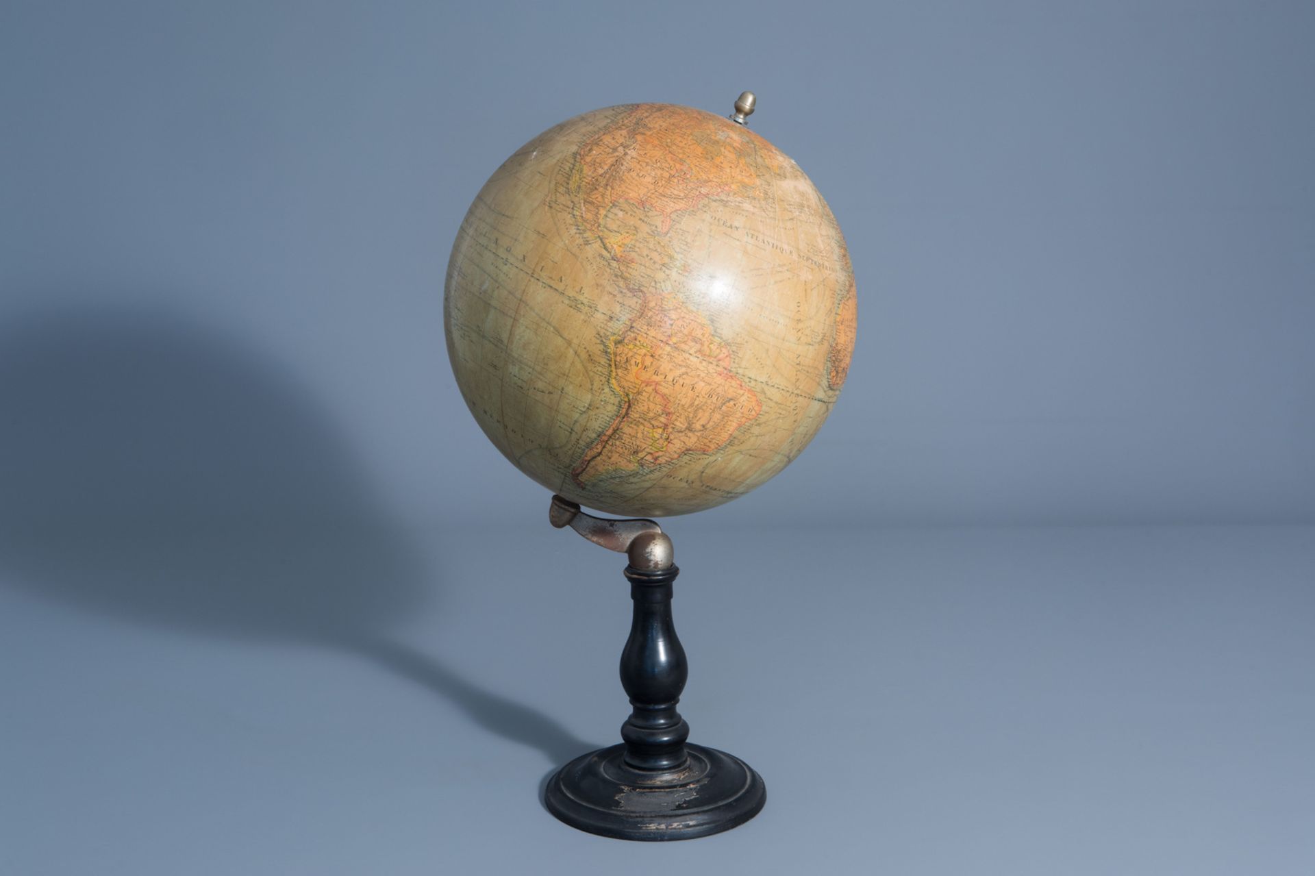 A Maison Delamarche globe on an ebonized wooden base, France, about 1900