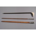 Two Chinese walking sticks with silver handles and one with a duck head shaped ivory handle, 19th/20