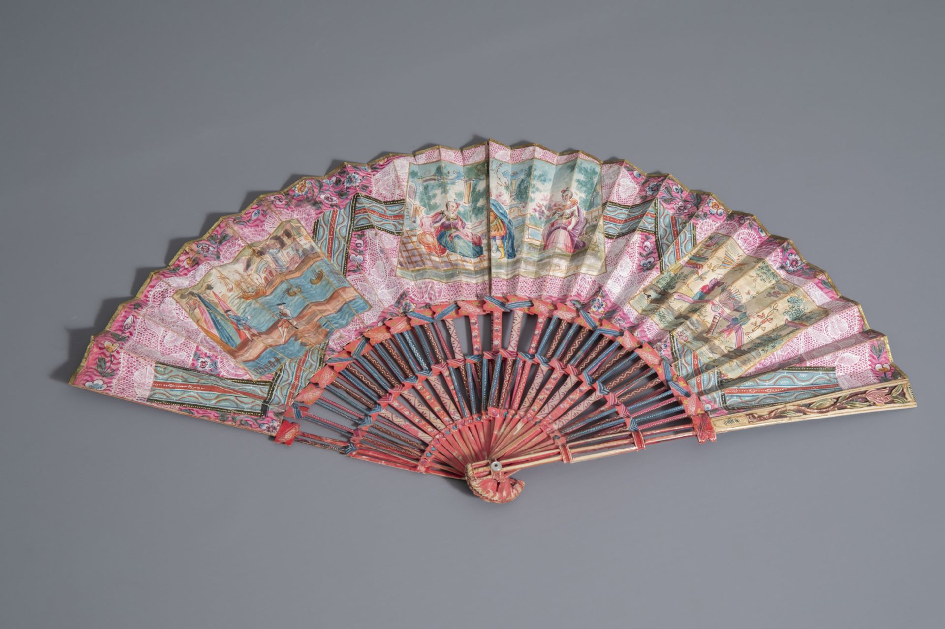 A French painted ivory and paper fan, in the original box, 19th C.