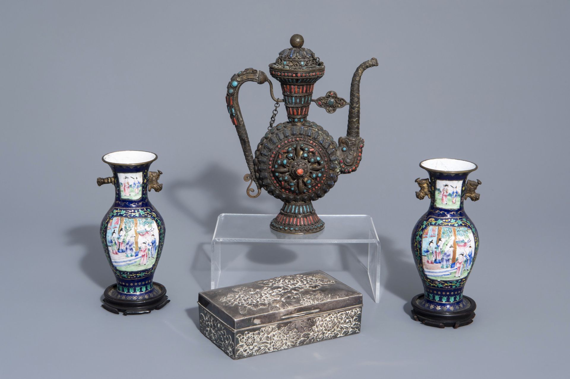A Chinese silver box and cover with floral design, a pair of cloisonnŽ vases and a Tibetan ewer with