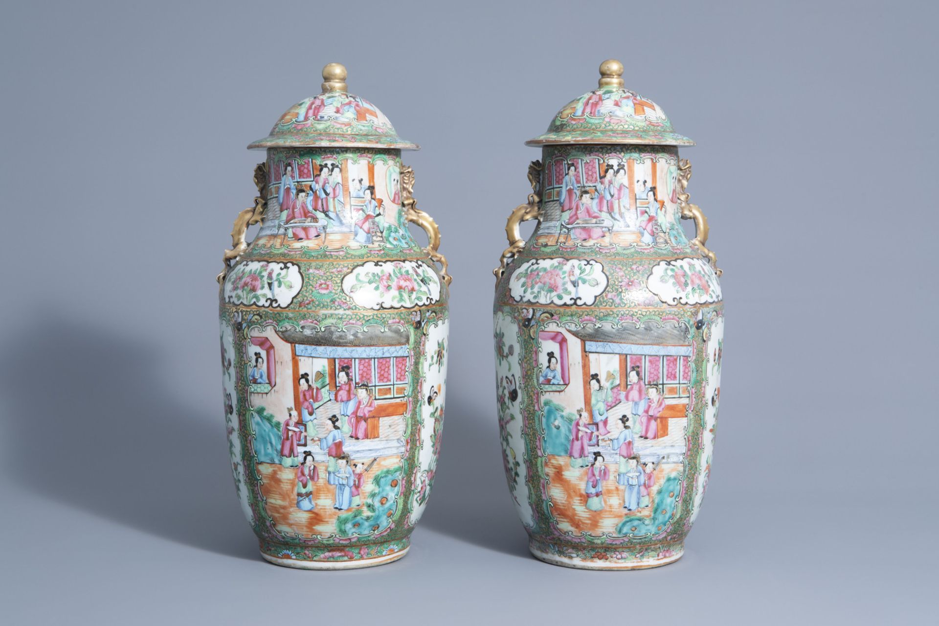 A pair of Chinese Canton famille rose vases and covers, 19th C.