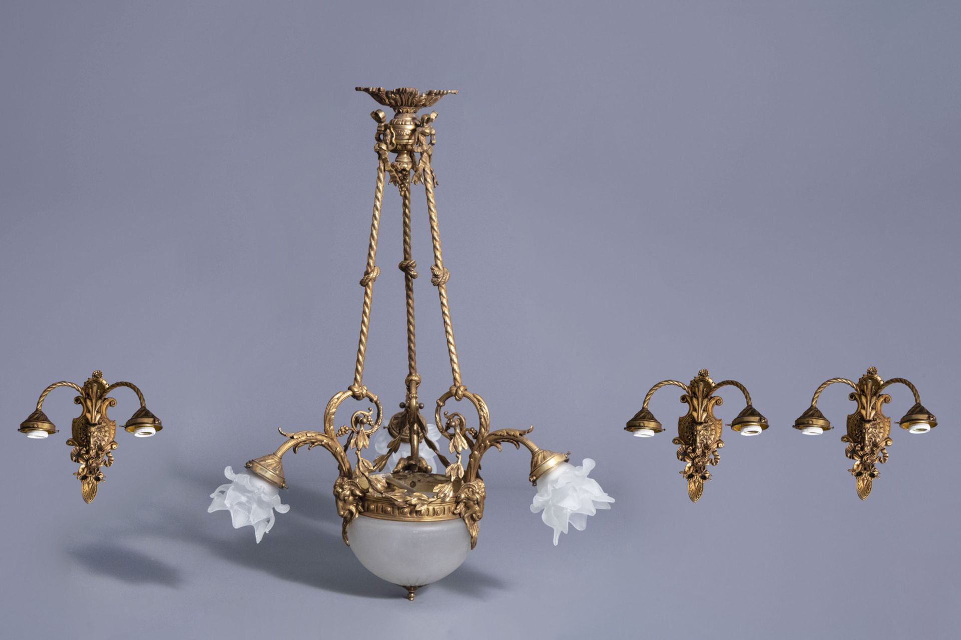 A historicizing gilt copper alloy chandelier with three accompanying wall appliques, 20th C.