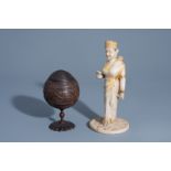 An Indian carved coconut beaker and cover and an alabaster figure of a deity with gilt design, 19th/