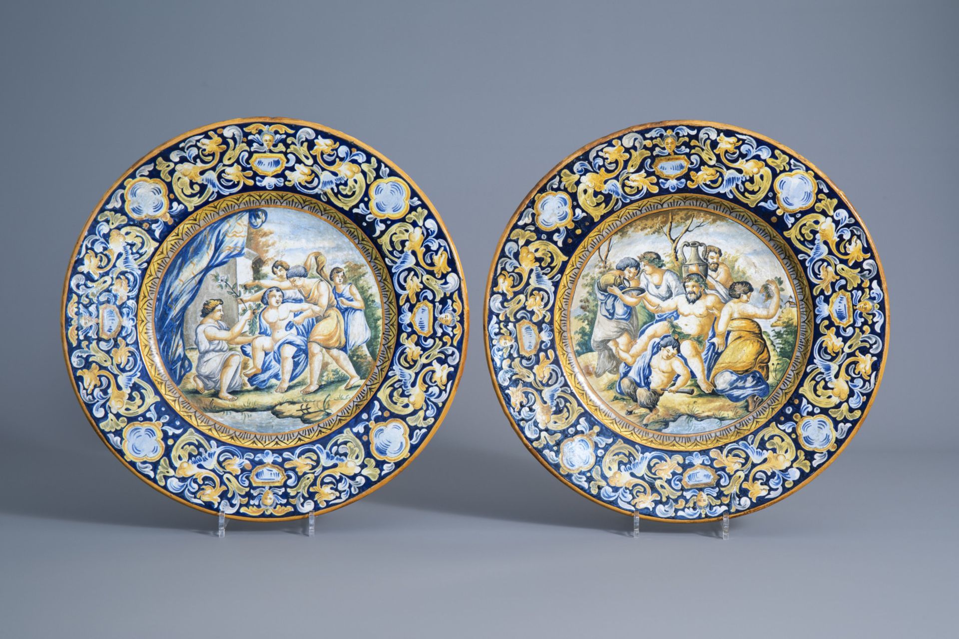Two Italian polychrome maiolica chargers with Bacchus scenes, about 1900