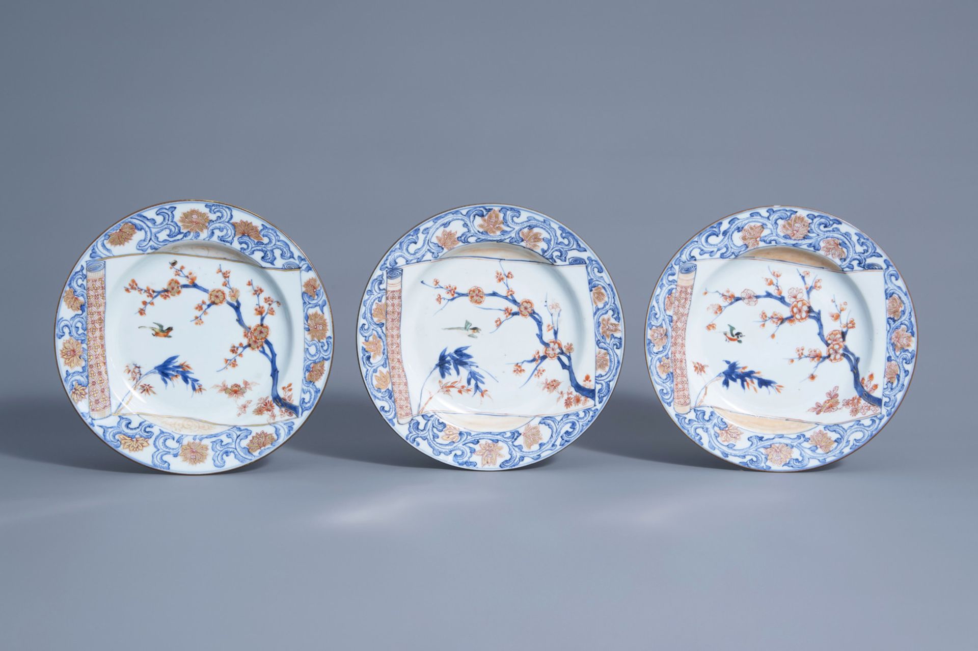Three Chinese Imari style plates with a scroll with a bird among blossoming branches, Yongzheng