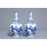 A pair of blue and white Delft style gadrooned bottle vases with birds among flower branches, Samson