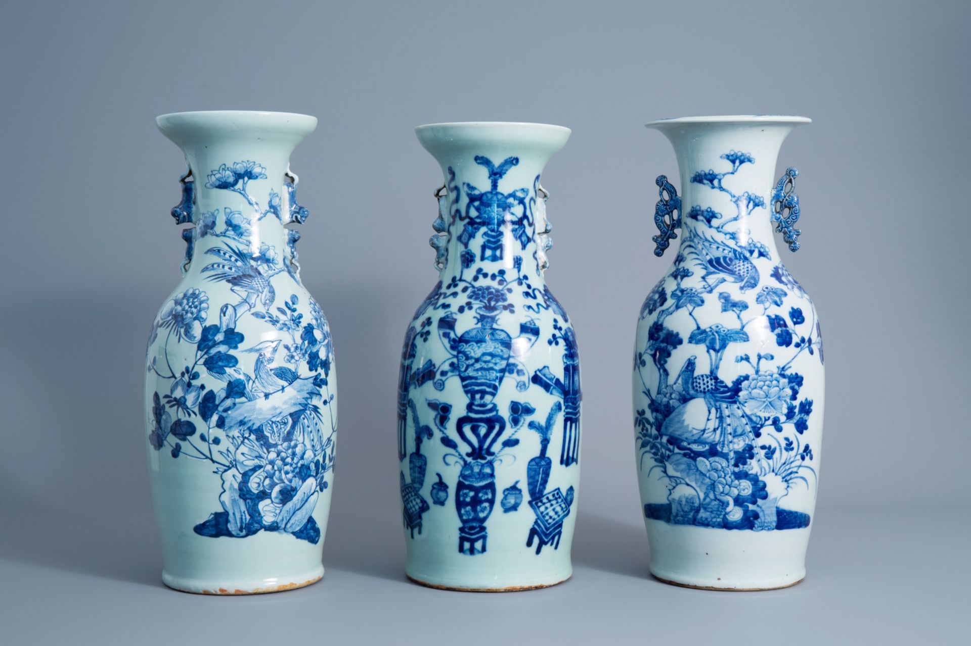 Three Chinese blue and white celadon vases with antiquities and birds among blossoms, 19th C.