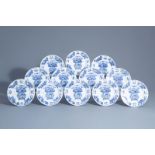 Twelve Chinese blue and white plates with in the center a flower basket and on the edges a floral de