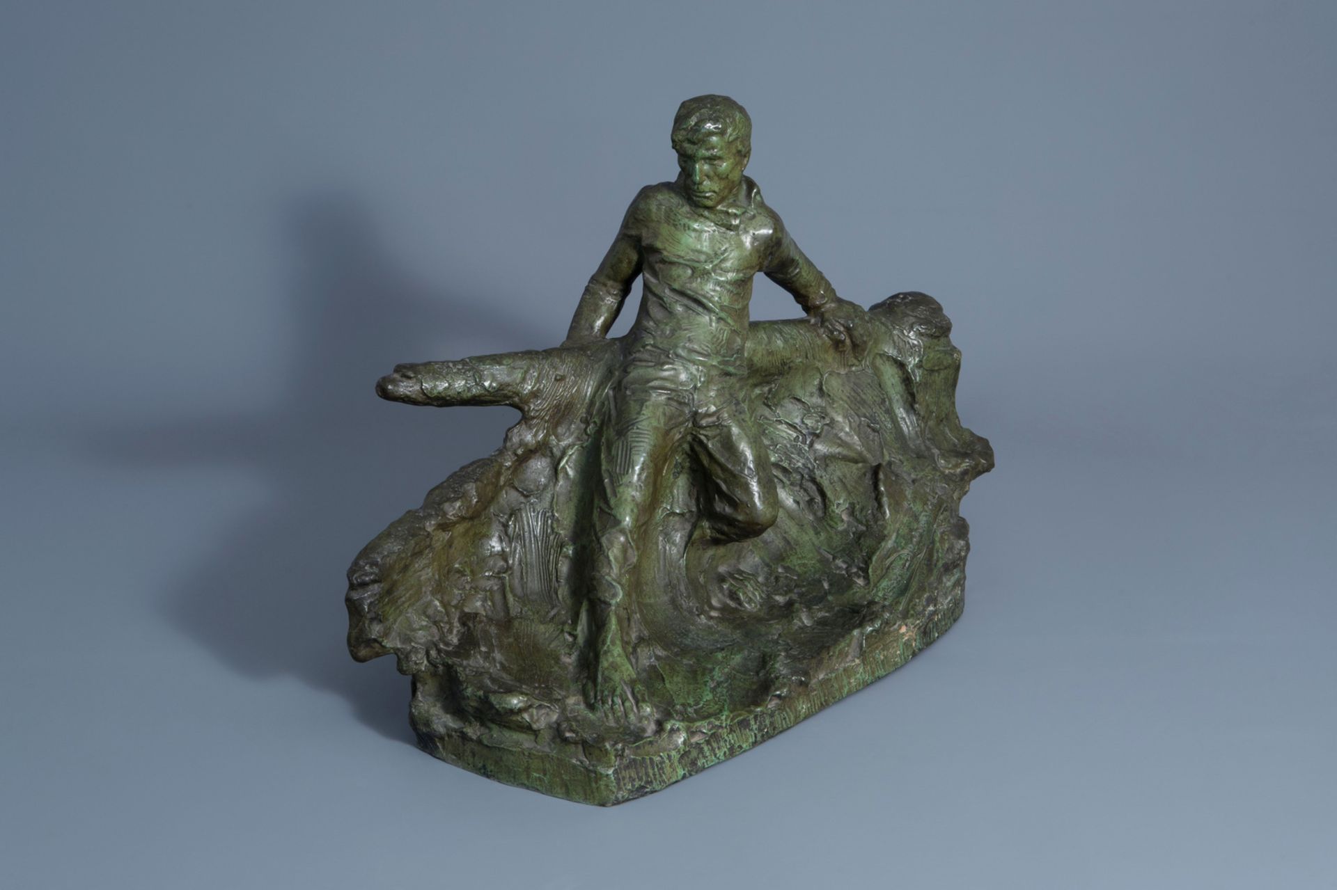 Victor Demanet (1895-1964): Man at the helm on a choppy sea, green patinated bronze