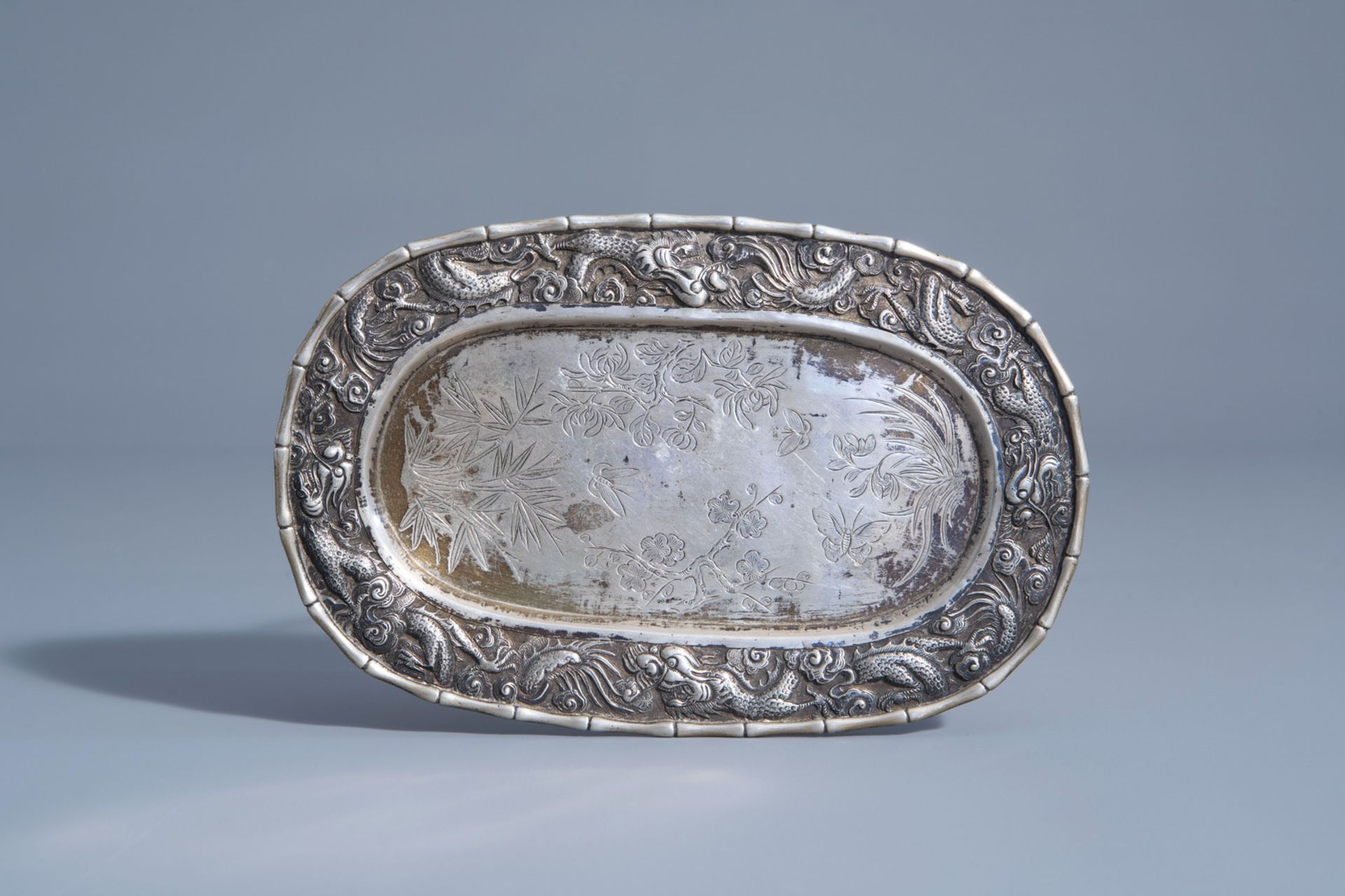 A Chinese export silver plate with dragons and floral design, 'Luen Wo' mark, about 1900
