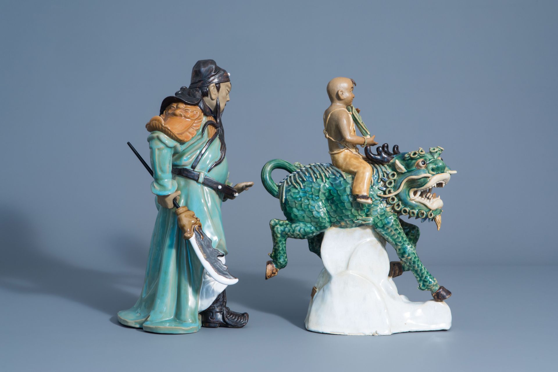 Two Chinese Shiwan pottery models of a warrior and a boy riding a Buddhist lion, 20th C. - Image 3 of 8