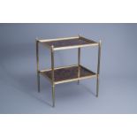 Maison Bagus, Paris: A rectangular gilt bronze two tier mirror tray side table, third quarter 20th
