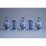 A Dutch Delft blue and white five-piece garniture with a bird among blossoming branches and a floral