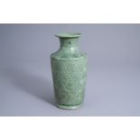 A Korean green glazed vase with floral relief design, 19th/20th C.