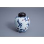 A Chinese blue, white and underglaze red jar with wooden cover, 20th C.