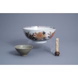 A Chinese Imari style bowl, a Yaozhou style bowl and a carved bone figure, possibly Song and later