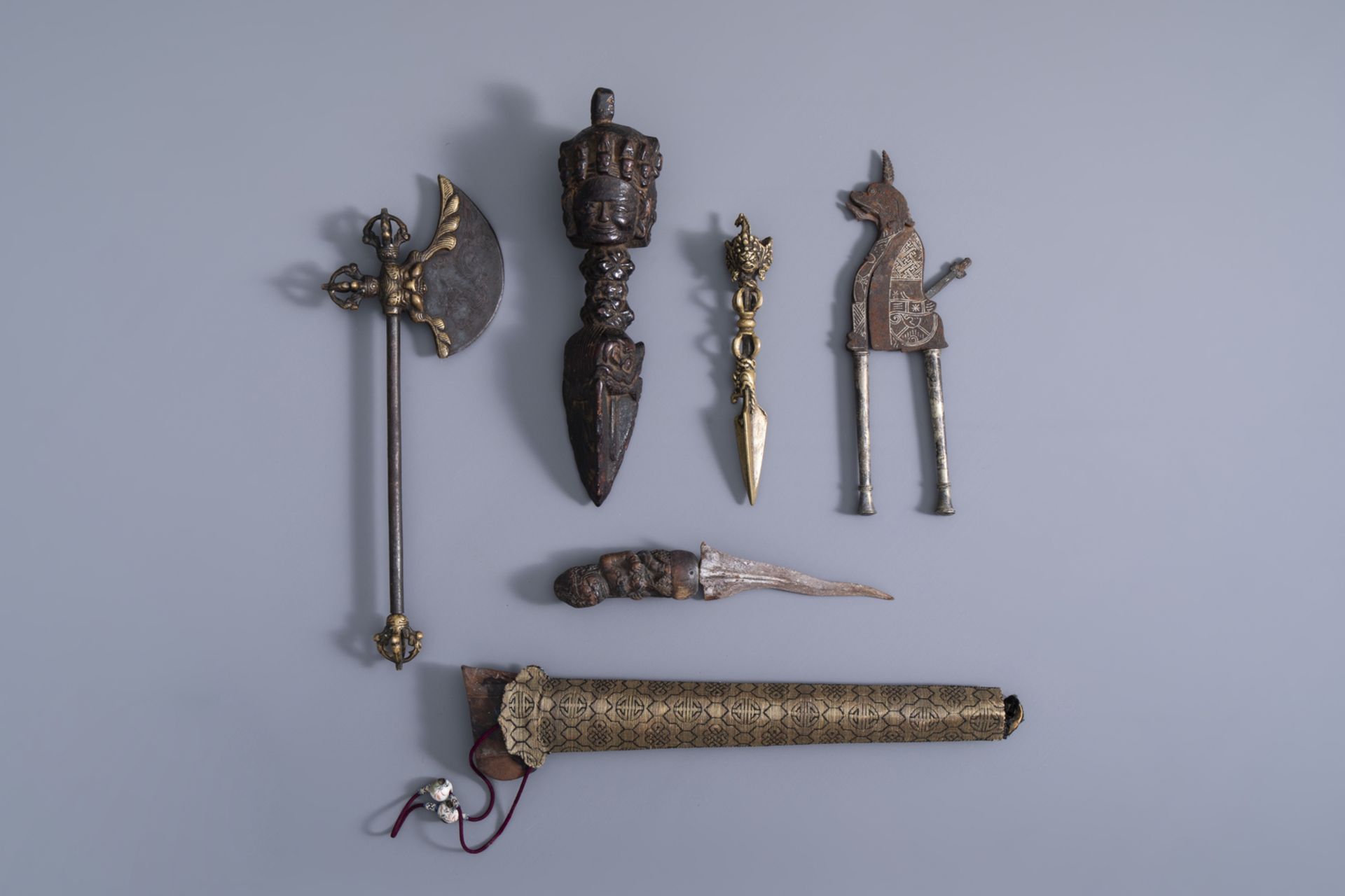 Three Tibetan miniature weapons, an Indonesian betel nut cracker and a kris, 19th/20th C.