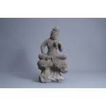 A Chinese carved stone figure of Buddha seated on a rock, Qing