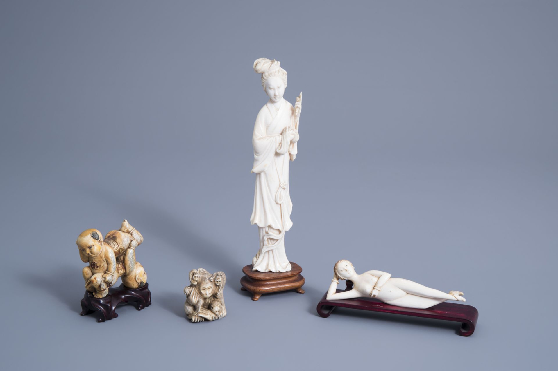 A Chinese ivory doctor's lady, a model of a lady, a pair of 'Hoho' brothers and a group of monkeys,