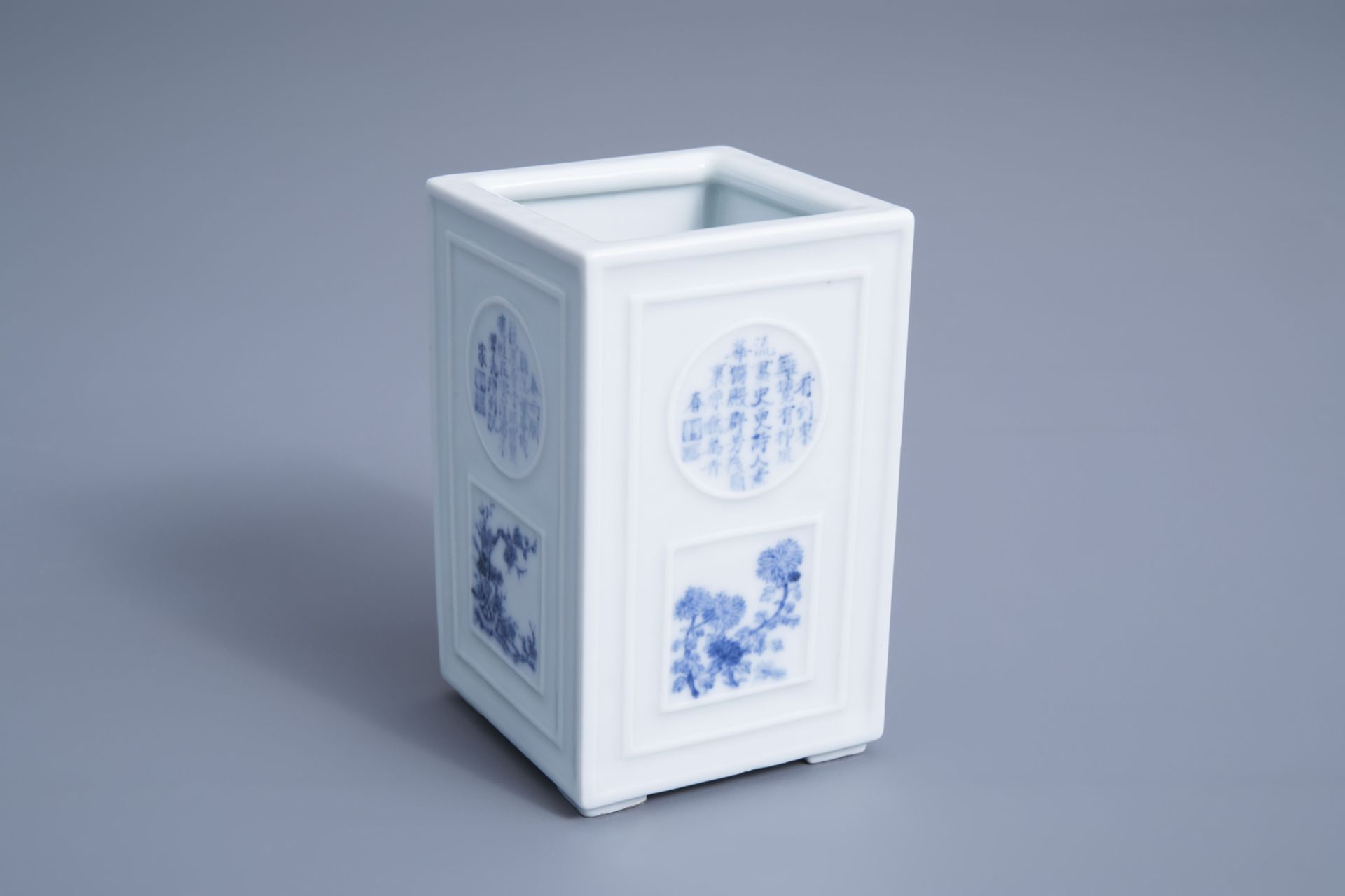 A square Chinese blue and white brush pot with poem medallions and floral design, Republic, 20th C.