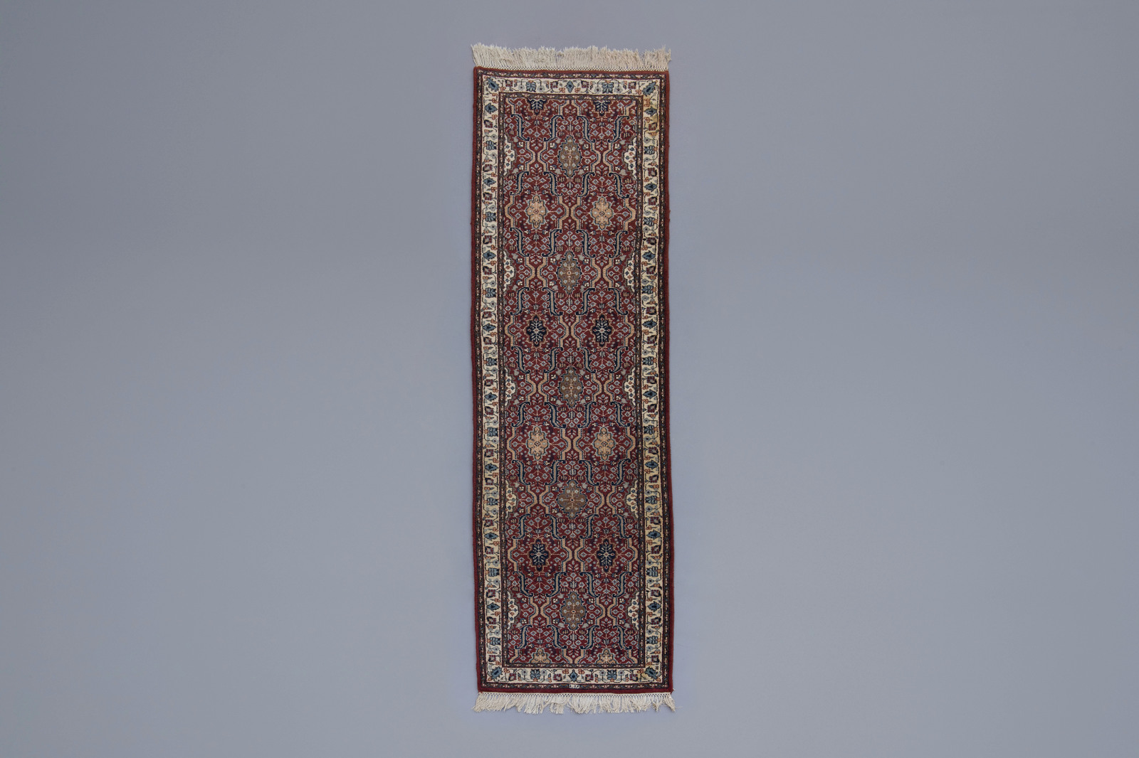 An Oriental runner with floral design, wool on cotton, 20th C.