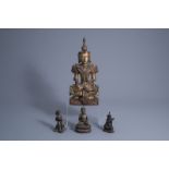 Three Chinese or Tibetan bronze figures and a Thai inlaid and gilt wooden Buddha figure, 19th/20th C