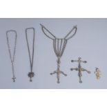 A varied collection of partly silver religious necklaces and crosses, various origins, 19th/20th C.