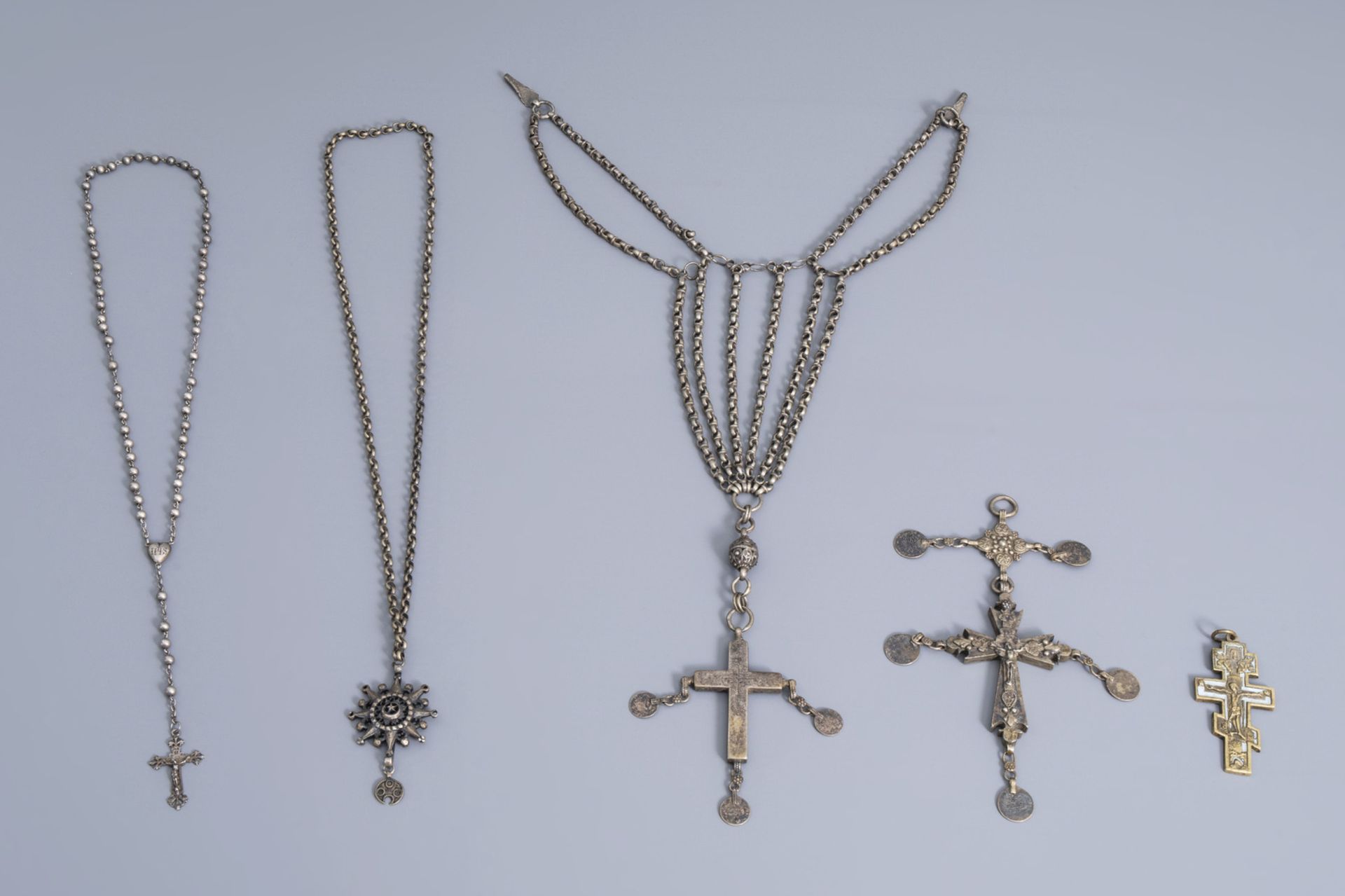 A varied collection of partly silver religious necklaces and crosses, various origins, 19th/20th C.