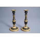 A pair of French gilt and patinated bronze candlesticks with acanthus leaves, 19th C.