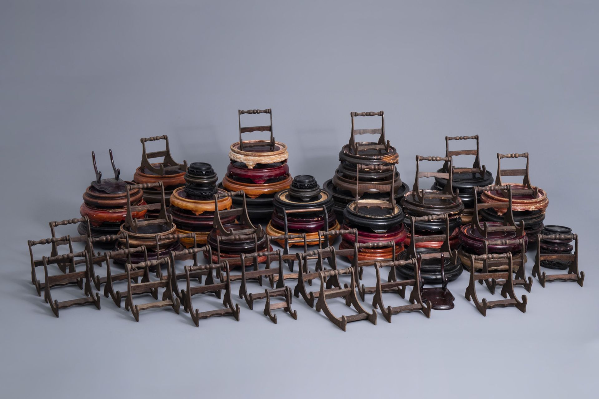A collection of Chinese wooden stands and a collection of plate holders, 19th/20th C.