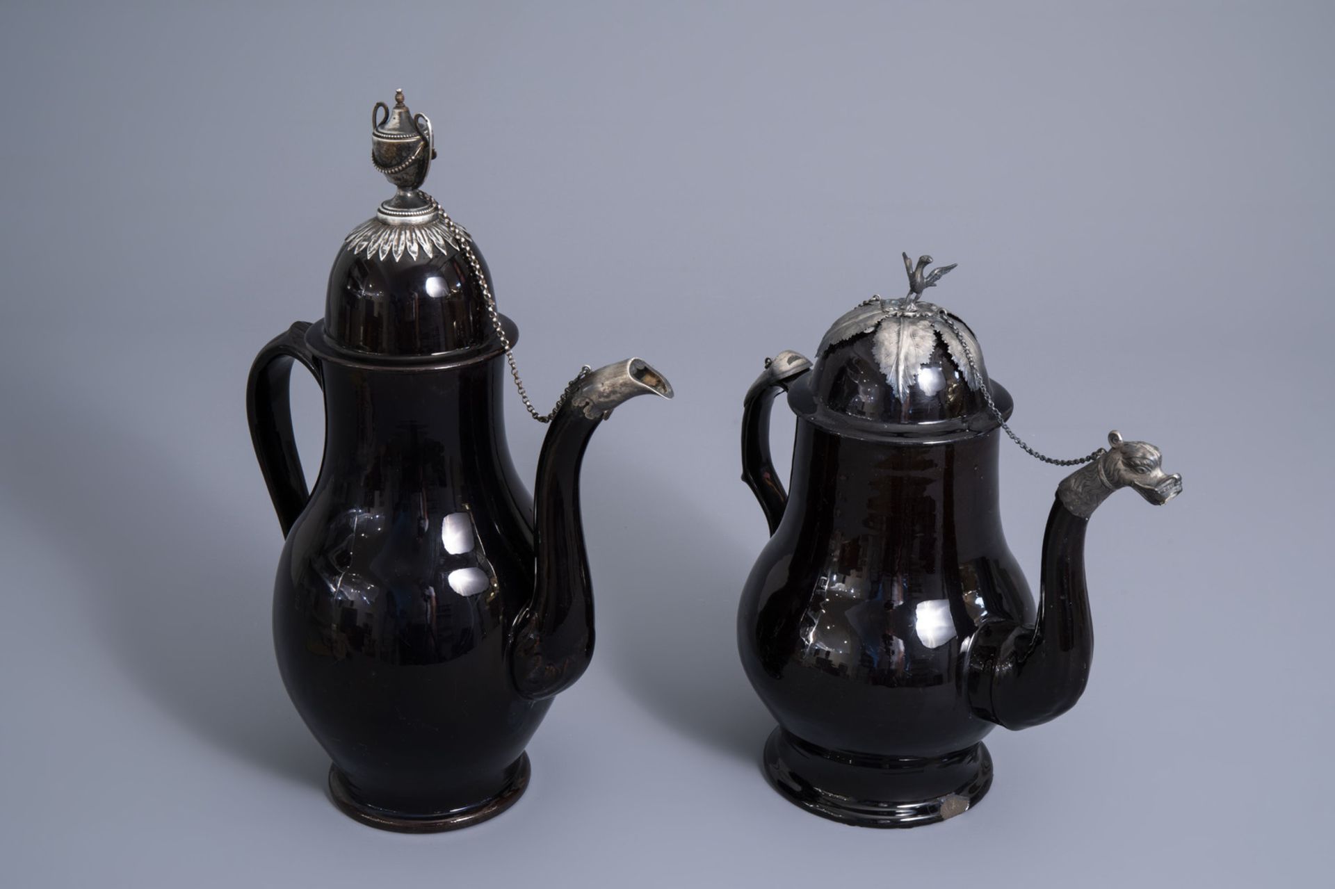 Two large silver mounted Namur black glazed pottery coffee pots, 18th C.