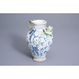 An Italian polychrome maiolica wet drug jar with floral 'a foglie' design and a text band, Montelupo