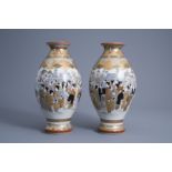 A pair of Japanese Satsuma vases with figures in a landscape overlooking mount Fuji, Meiji