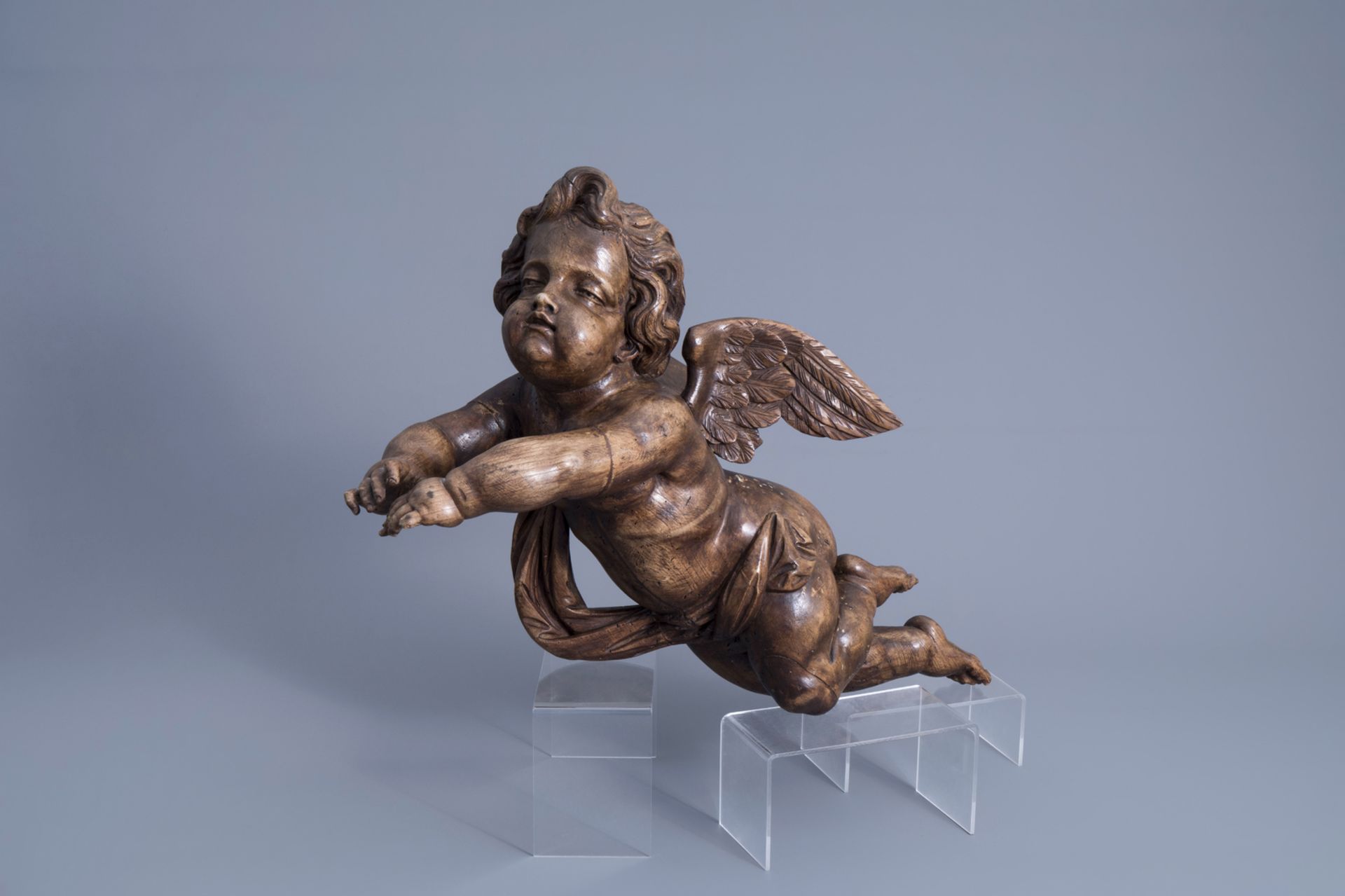 A patinated carved wooden figure of a putto, Southern Netherlands, 18th C.