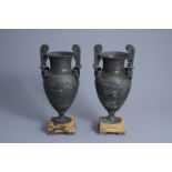 A pair of Neoclassical style vases with charioteers on a Siena marble base, 19th/20th C.