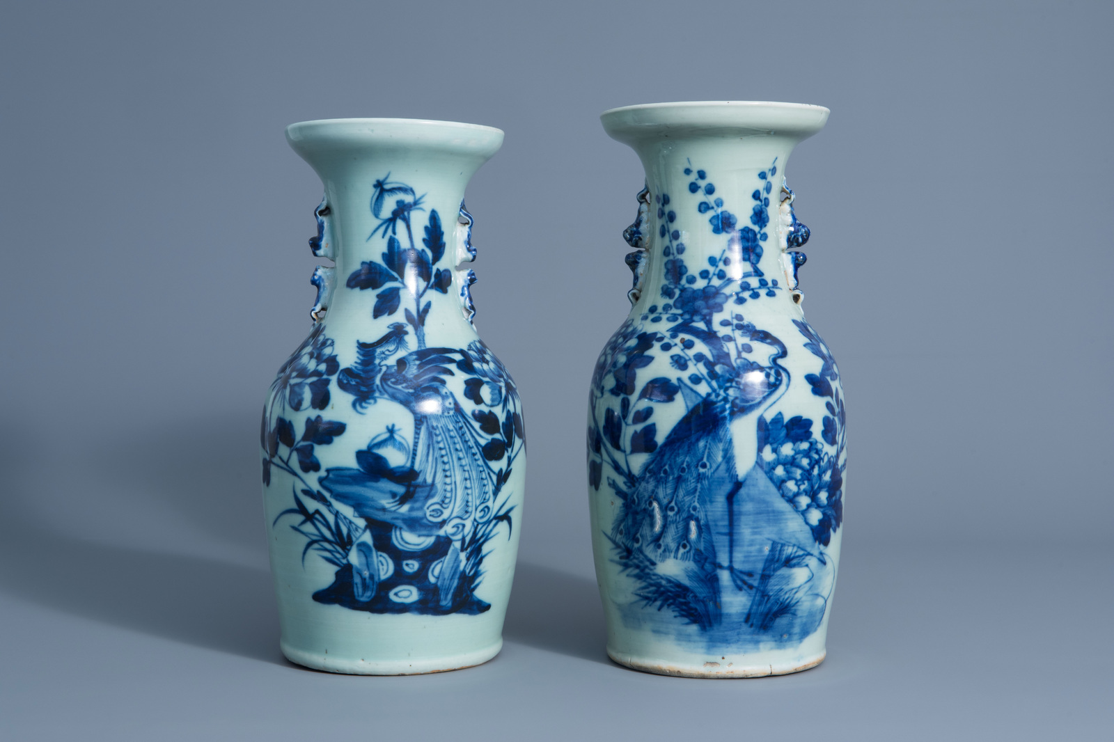 Two Chinese blue and white celadon vases with peacocks on a rock, 19th C.