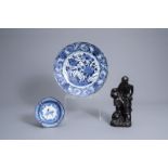 Two Japanese blue and white Arita dishes and a black glazed figure of an immortal, Edo/Meiji