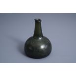 A Dutch dark green waldglas onion wine bottle or 'Kattekop', 17th/18th C.