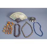 A varied collection of Asian beads, a fan and an inlaid silver box, 19th/20th C.