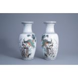 A pair of Chinese famille rose vases with peacocks among blossoming branches, Qianlong mark, 20th C.