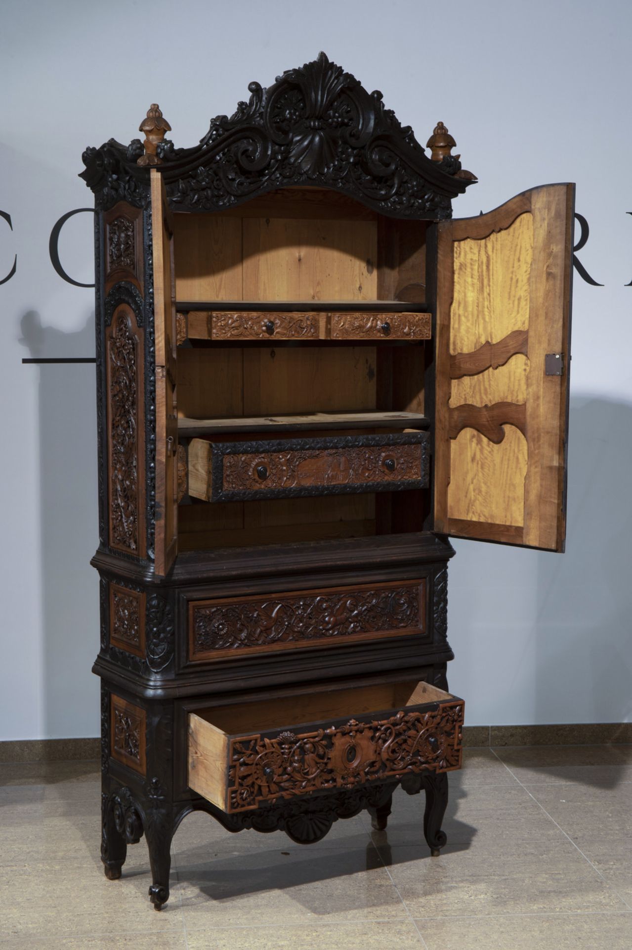 A colonial inspired and orientalist carved and ebonised wooden cabinet, first half of the 20th C. - Image 2 of 8