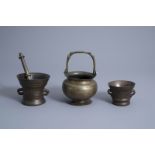 A brass holy water bucket and two bronze mortars and a pestle, Italy and the Low Countries, 16th/17t