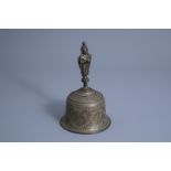 An Indian engraved bronze bell with animals between flower tendrils, 19th/20th C.