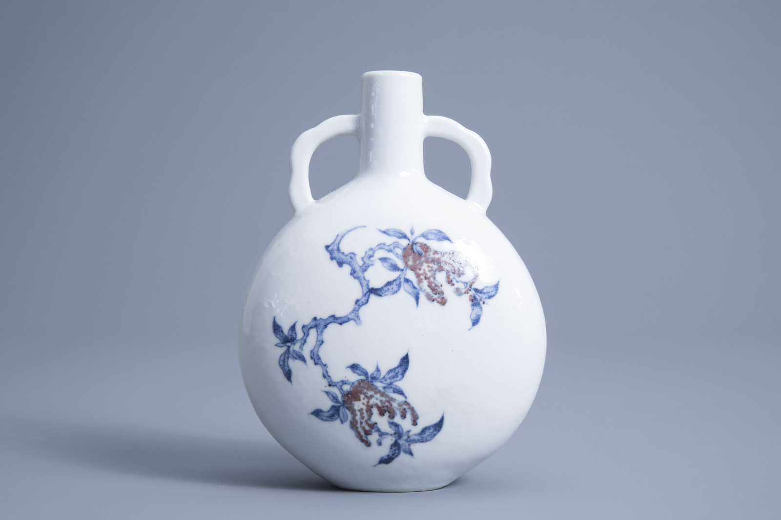 A Chinese blue, white and underglaze red moon flask, Qianlong mark, 19th/20th C.